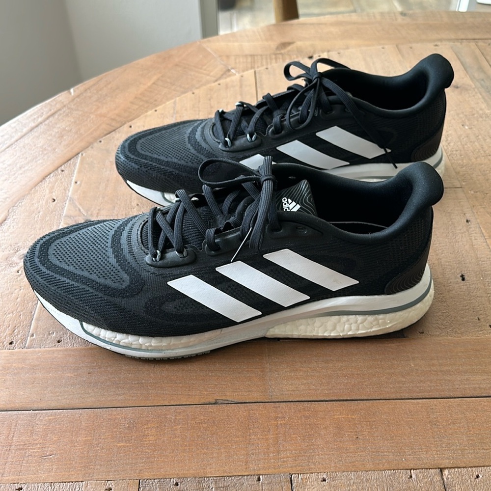 Adidas Men’s Supernova +  Black with White Stripes NWOT Men’s size 8.5